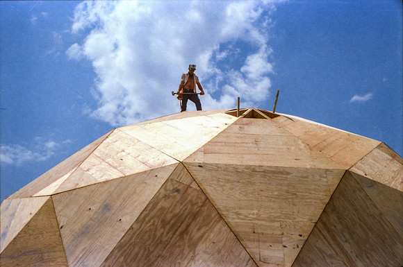 Guy with sledge hammer helping the place the final triangle