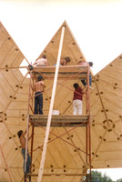 1 of 90 triangles (about 10' on a side) lifted up scaffolding & being put in place