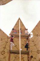 1 of 90 triangles (about 11' tall) lifted up scaffolding & being put in place