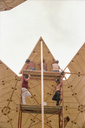 1 of 90 triangles (about 11' tall) lifted up scaffolding & being put in place